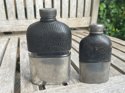 Pair of Vintage Leather & Metal Hip Flasks – Travel Companion Bottles with Removable Cups, Early to Mid 20th Century