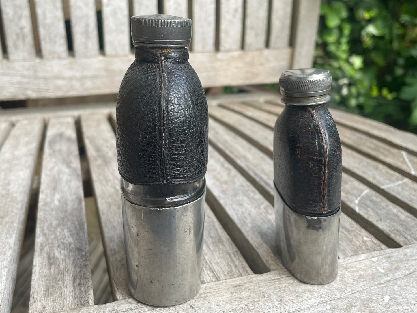 Pair of Vintage Leather & Metal Hip Flasks – Travel Companion Bottles with Removable Cups, Early to Mid 20th Century