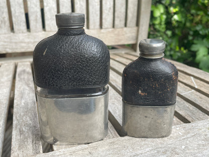 Pair of Vintage Leather & Metal Hip Flasks – Travel Companion Bottles with Removable Cups, Early to Mid 20th Century