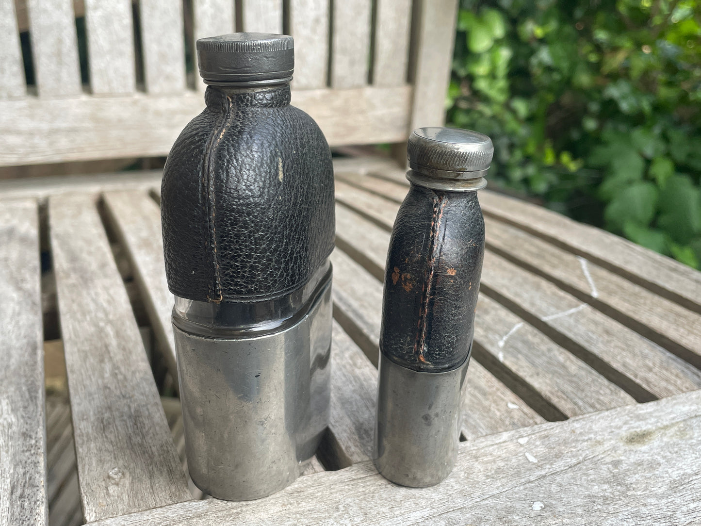 Pair of Vintage Leather & Metal Hip Flasks – Travel Companion Bottles with Removable Cups, Early to Mid 20th Century