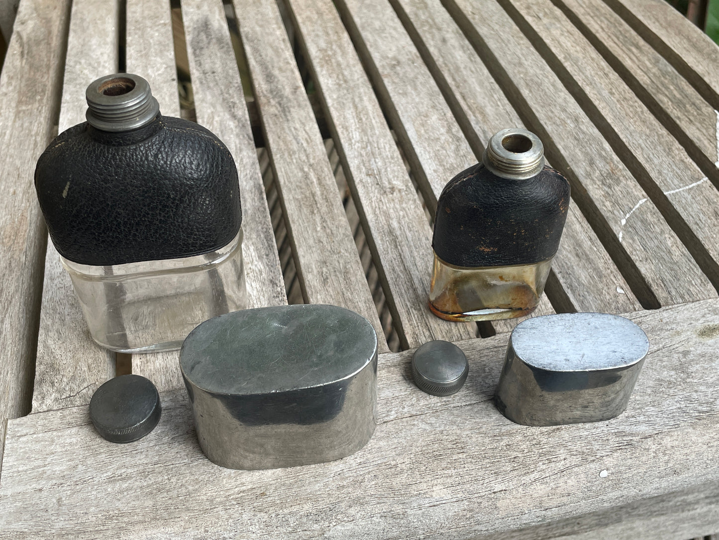 Pair of Vintage Leather & Metal Hip Flasks – Travel Companion Bottles with Removable Cups, Early to Mid 20th Century