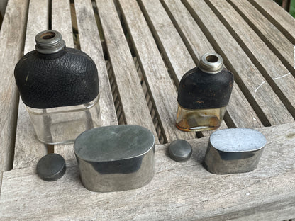 Pair of Vintage Leather & Metal Hip Flasks – Travel Companion Bottles with Removable Cups, Early to Mid 20th Century