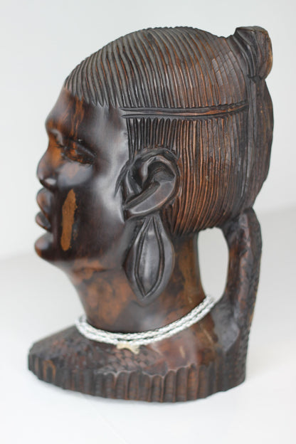 A substantial African hard wood carving of a female's head