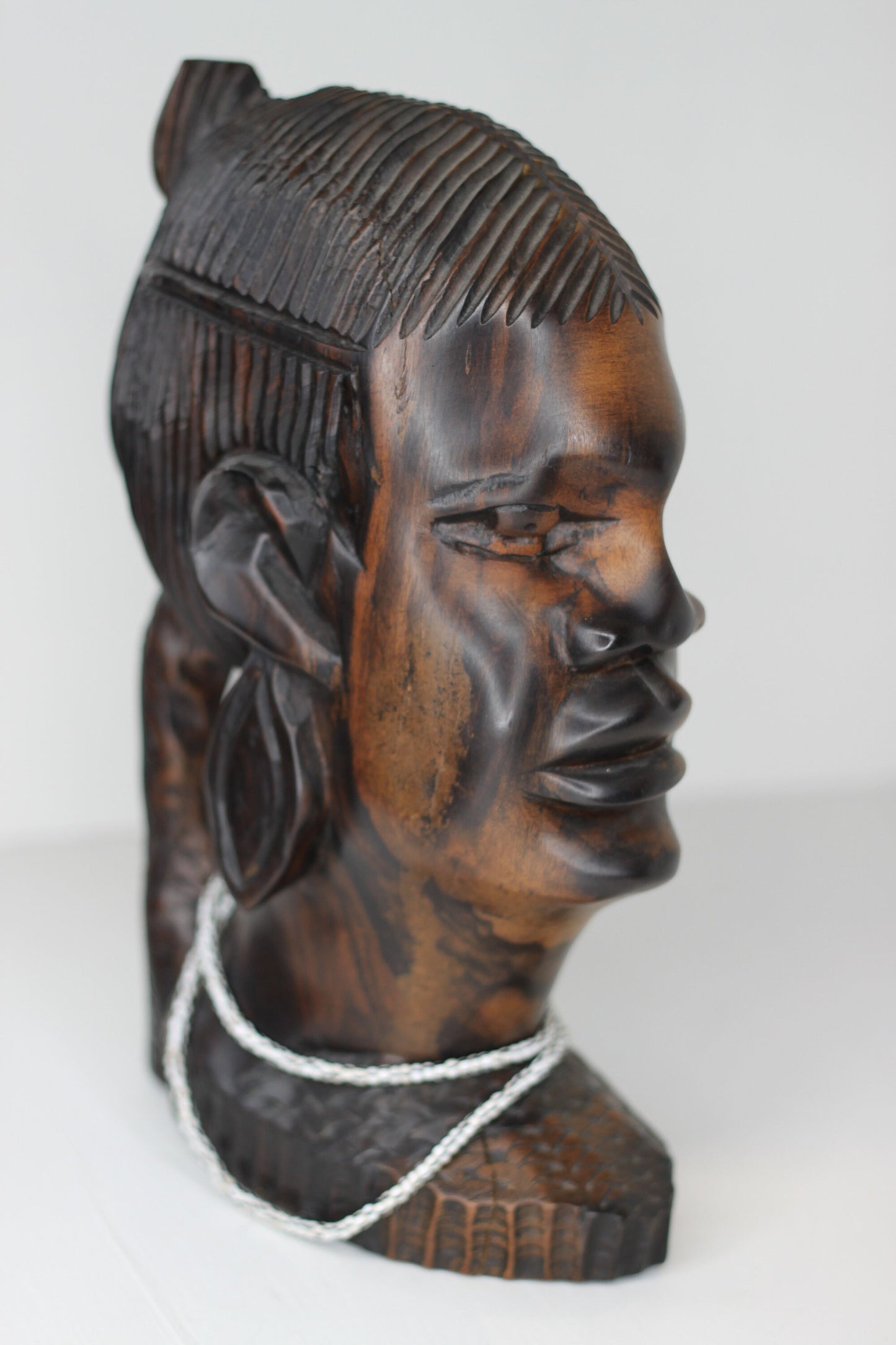 A substantial African hard wood carving of a female's head