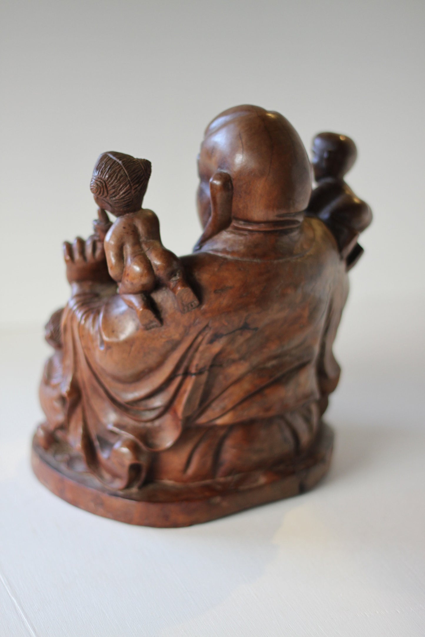 A Chinese, hand carved, unique wood Group of Budai and five infants