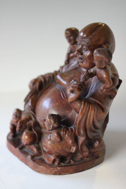 A Chinese, hand carved, unique wood Group of Budai and five infants