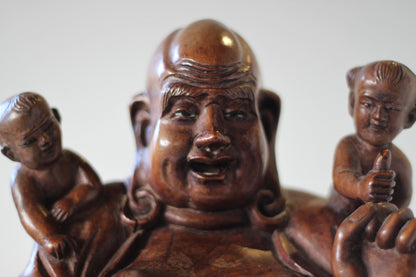 A Chinese, hand carved, unique wood Group of Budai and five infants