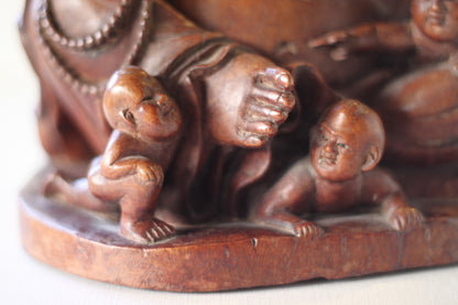 A Chinese, hand carved, unique wood Group of Budai and five infants