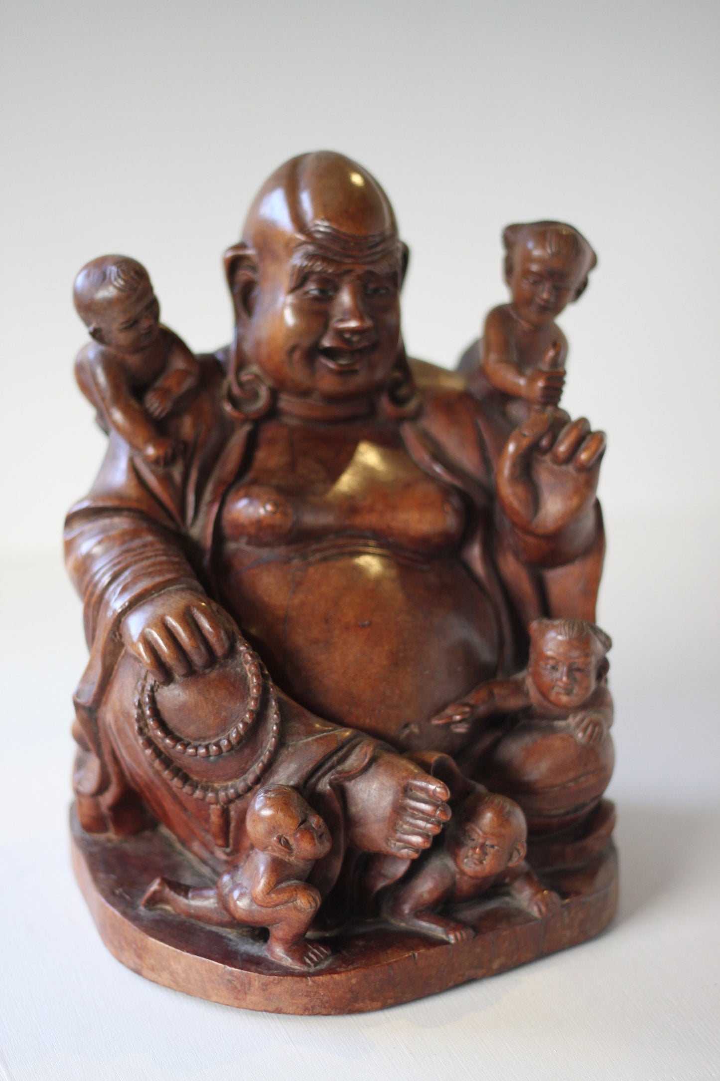 A Chinese, hand carved, unique wood Group of Budai and five infants