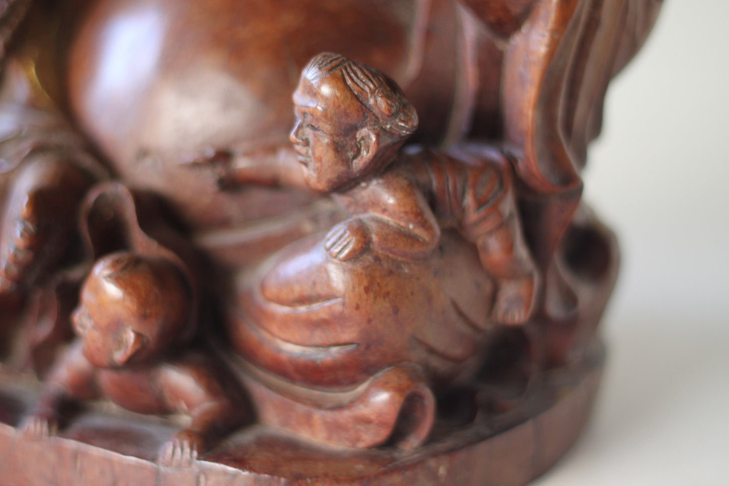 A Chinese, hand carved, unique wood Group of Budai and five infants