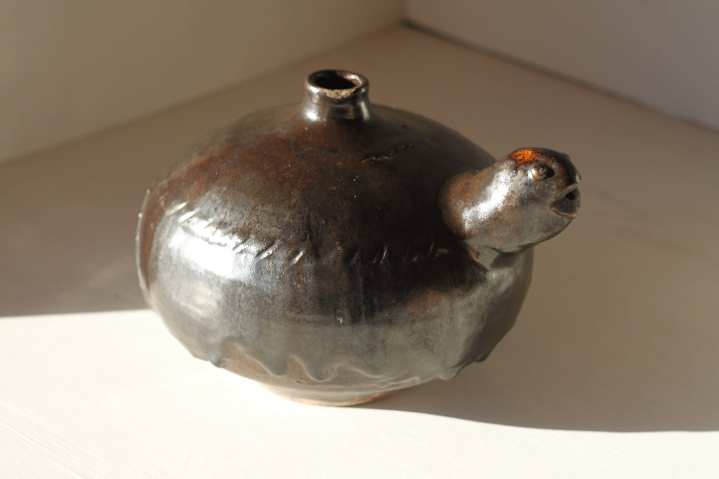 A South East Asian Black Glazed Pottery Tortoise Kendi, possibly Indonesian, 20cms wide Provenance