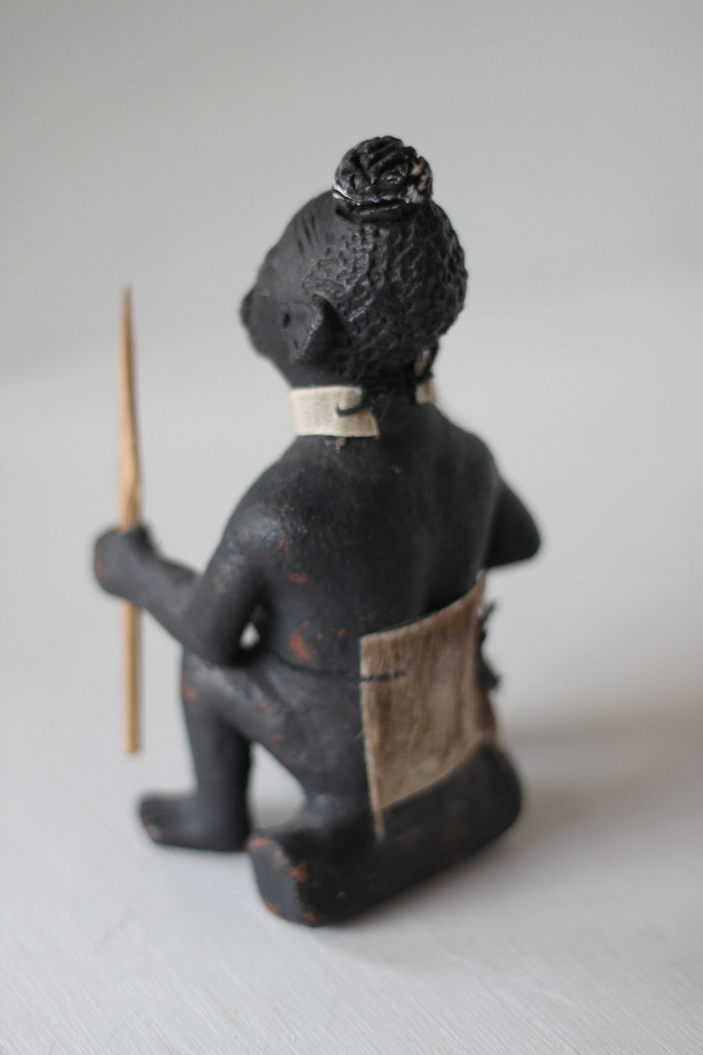 An Original Hand Made One Off Pottery Tribal Figurine in Traditional Dress and With Spear