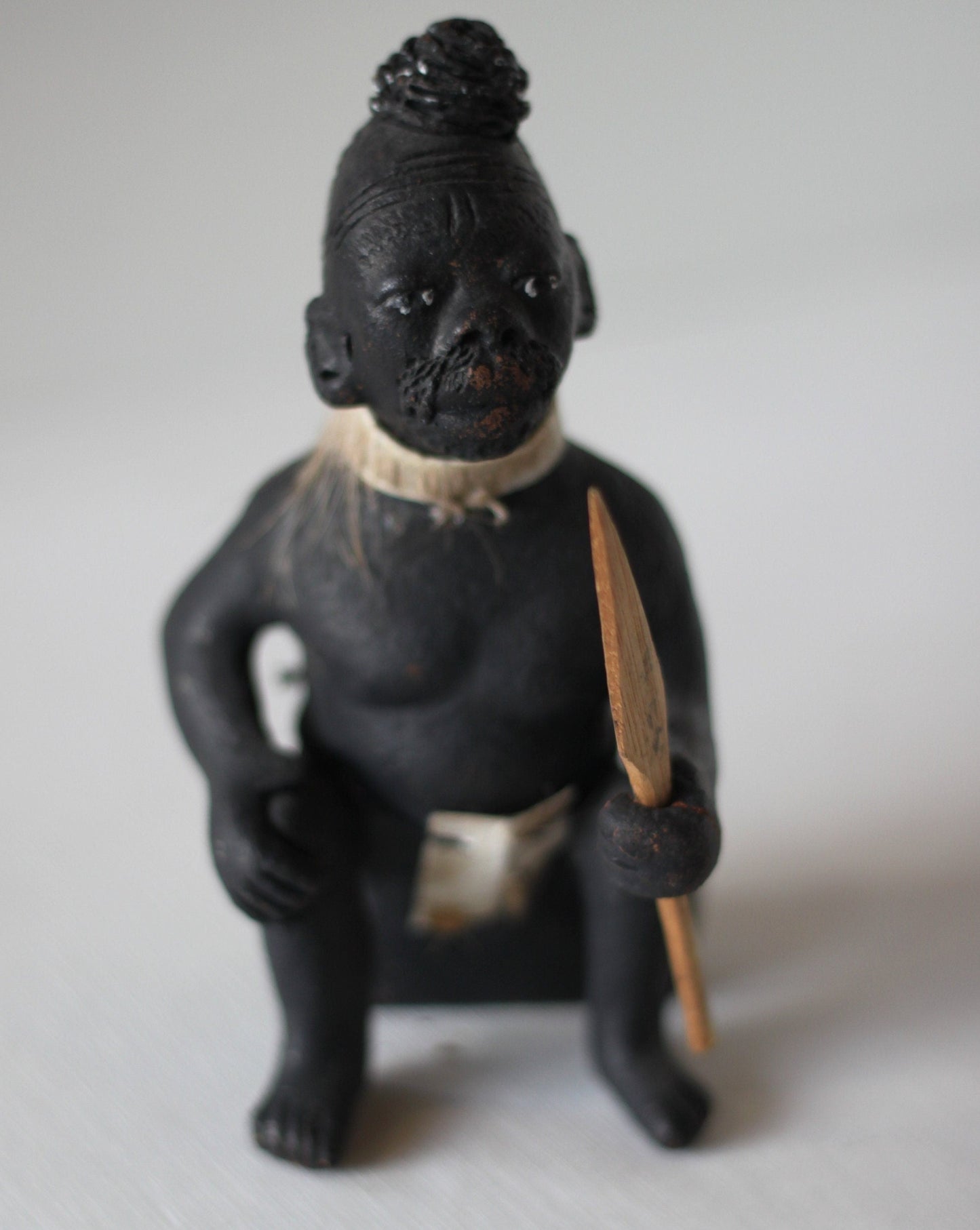 An Original Hand Made One Off Pottery Tribal Figurine in Traditional Dress and With Spear