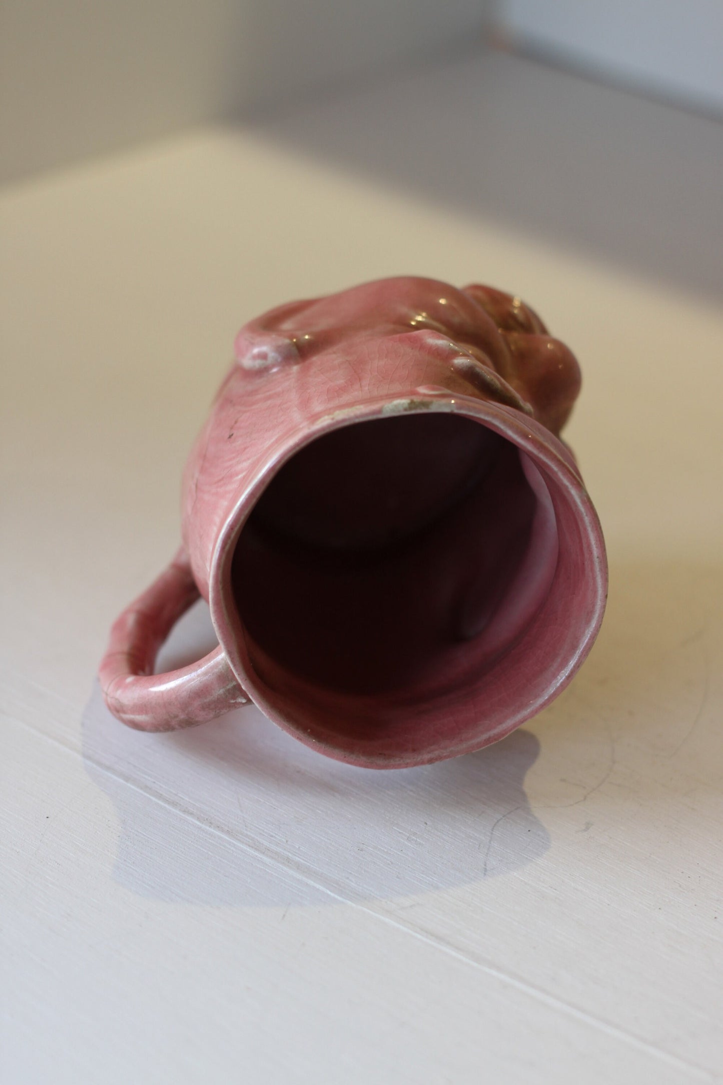 A Vintage Dusky Pink Glazed Military Mug in The Form of Bruce Bairnsfather's Old Bill, 11.5cm high