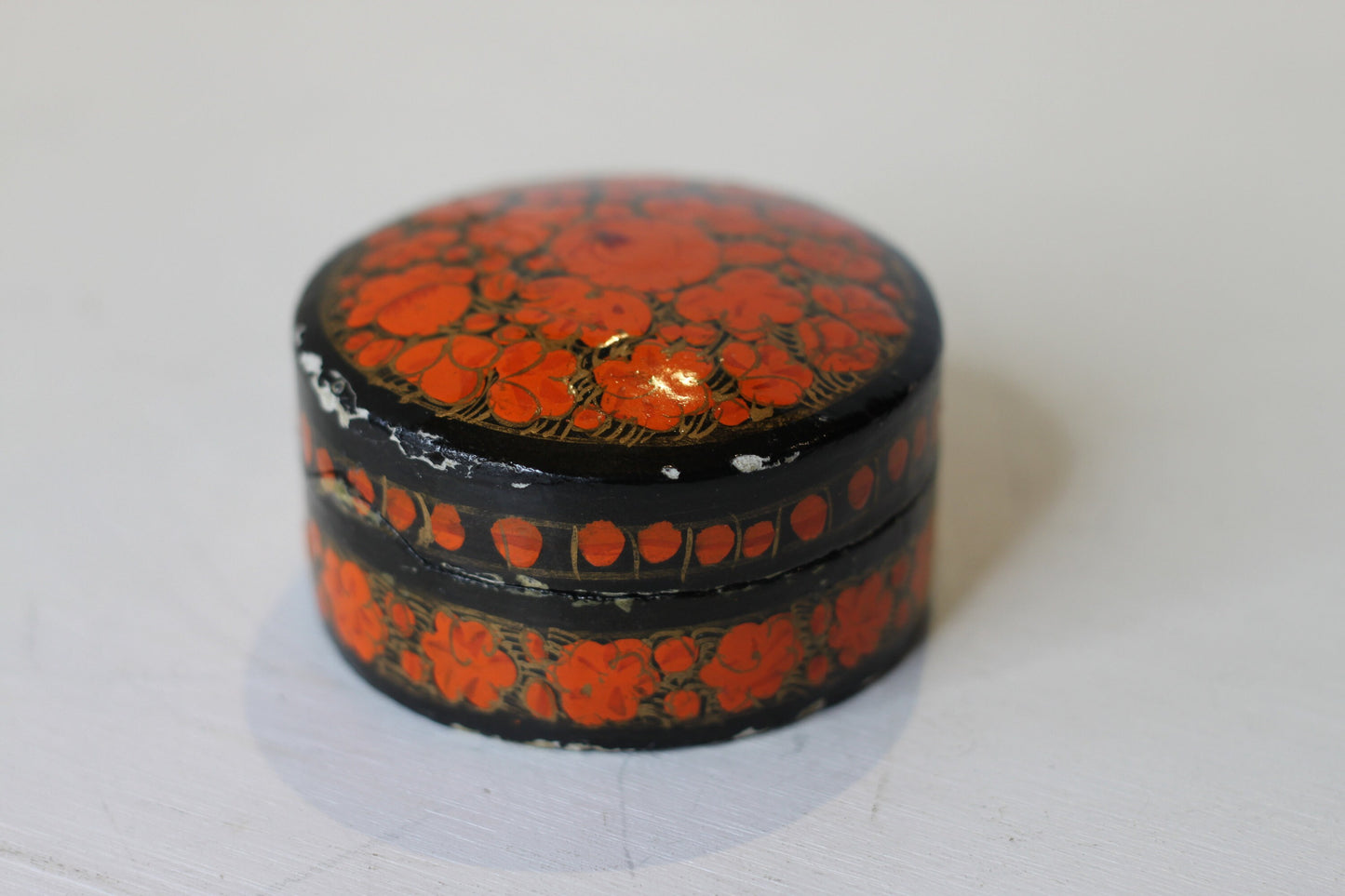 an Indian lacquered papier-mch box and cover hand painted with orange flowers