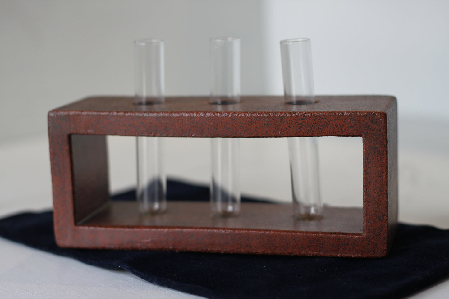 A Studio Pottery Glazed Brick-Form Test Tube Rack Vase