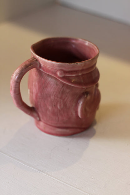 A Vintage Dusky Pink Glazed Military Mug in The Form of Bruce Bairnsfather's Old Bill, 11.5cm high