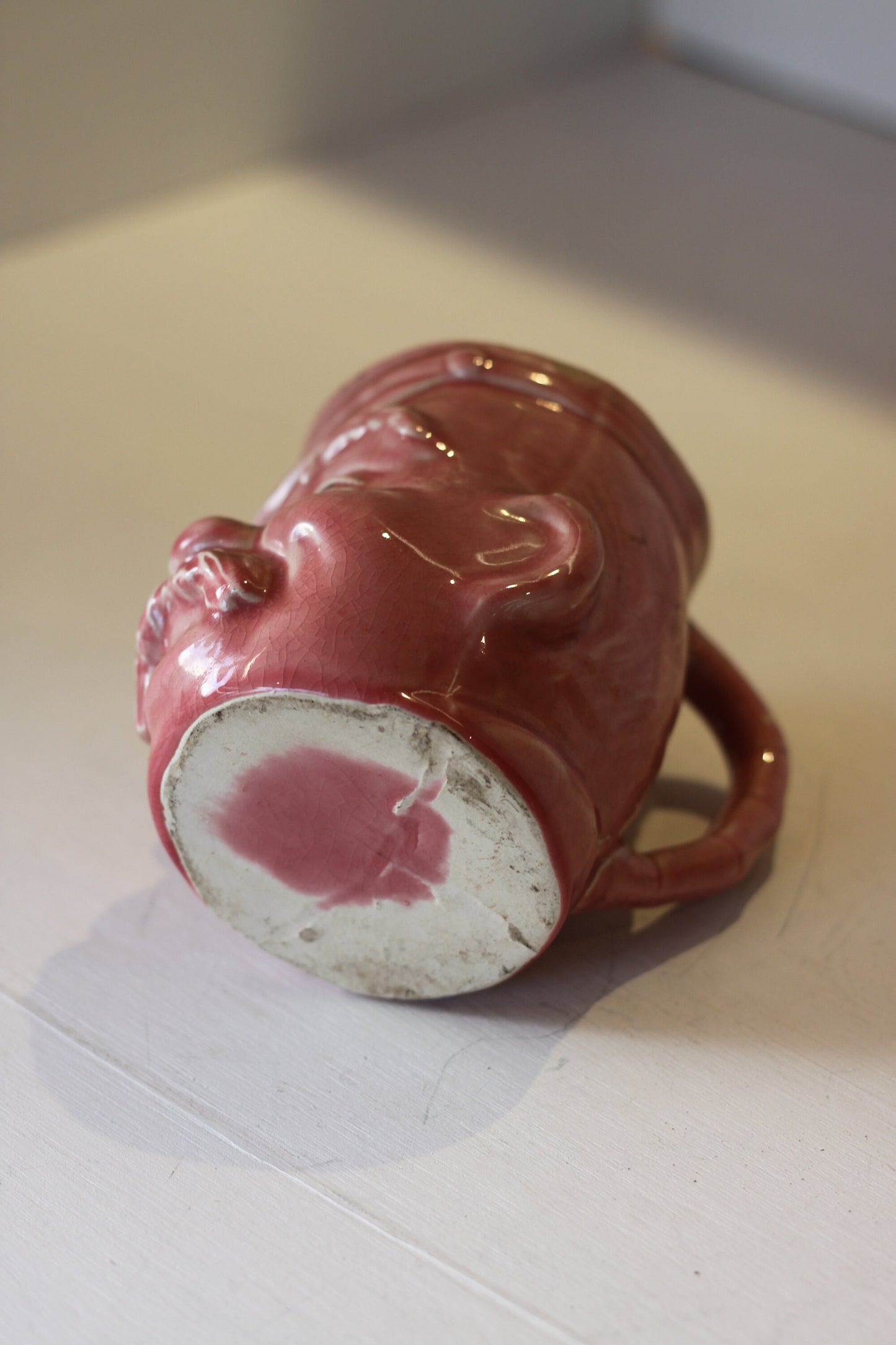 A Vintage Dusky Pink Glazed Military Mug in The Form of Bruce Bairnsfather's Old Bill, 11.5cm high