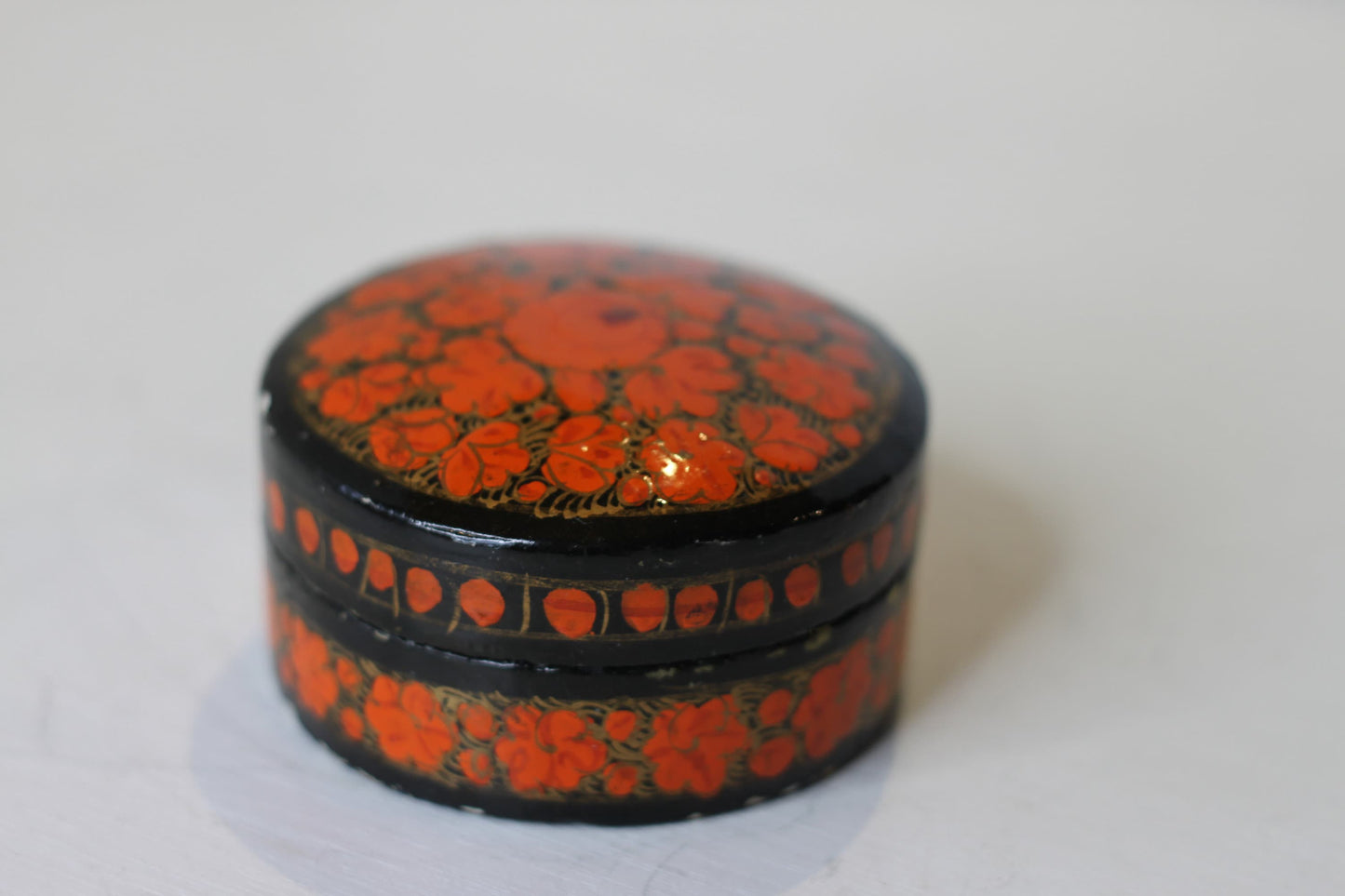 an Indian lacquered papier-mch box and cover hand painted with orange flowers