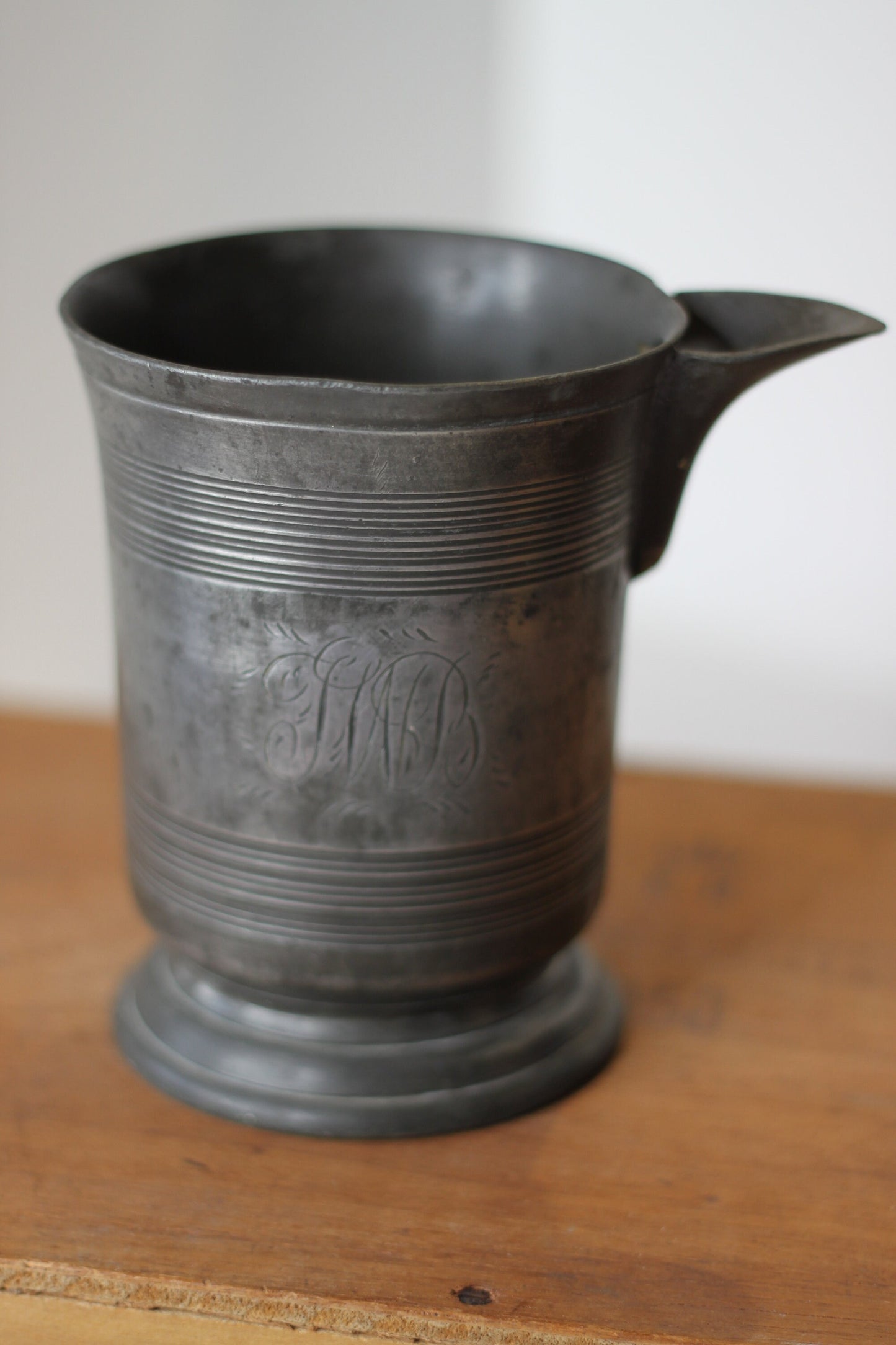 A 19th Century Pewter Side-Pouring Jug With Verification Marks, Engraved Cartouche and Base With a W&M Stamp