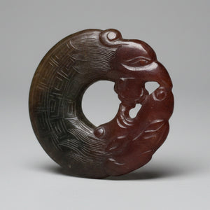 A Chinese Red Hardstone Bi Disc/Pendant  6.5cm Across