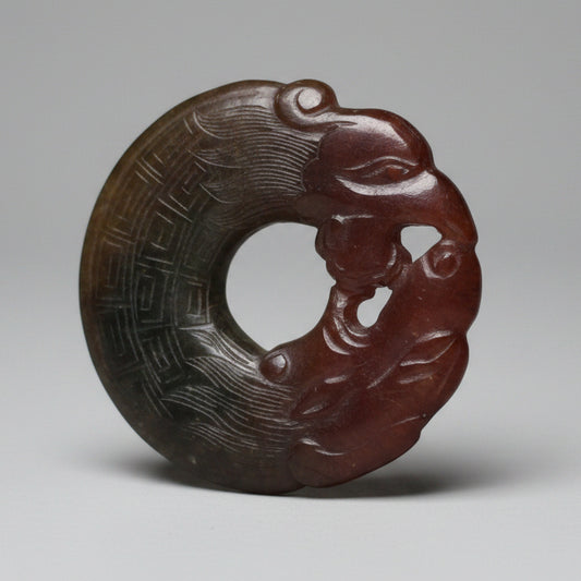 A Chinese Red Hardstone Bi Disc/Pendant  6.5cm Across