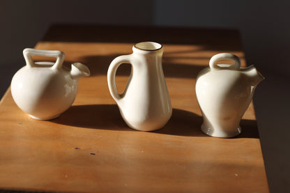 Two W.H Goss Crest ware, Lampeter Jug, Gloucester Ancient Pitcher and an Arcadian Wareham pitcher