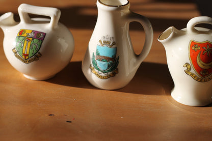 Two W.H Goss Crest ware, Lampeter Jug, Gloucester Ancient Pitcher and an Arcadian Wareham pitcher