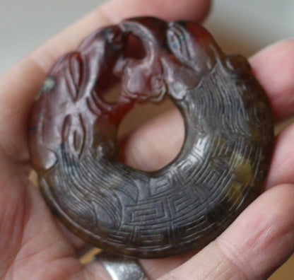 A Chinese Red Hardstone Bi Disc/Pendant  6.5cm Across