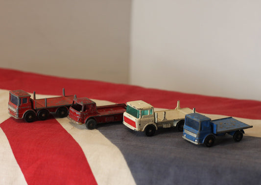 Four Diecast Metal Matchbox Lesney and Husky Toy Trucks From The 1960's