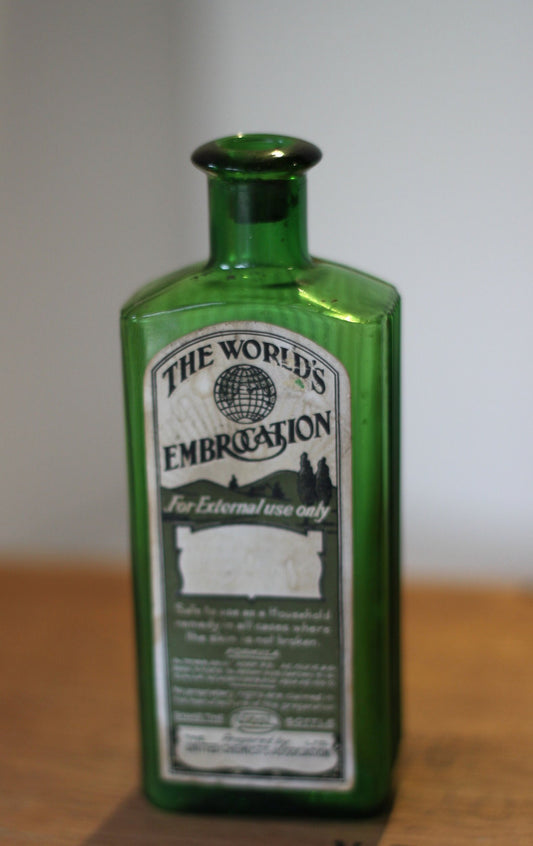 A Gorgeous Vintage Green Ribbed Bottle With its Original Label for 'The Worlds Embrocation" Excellent condition