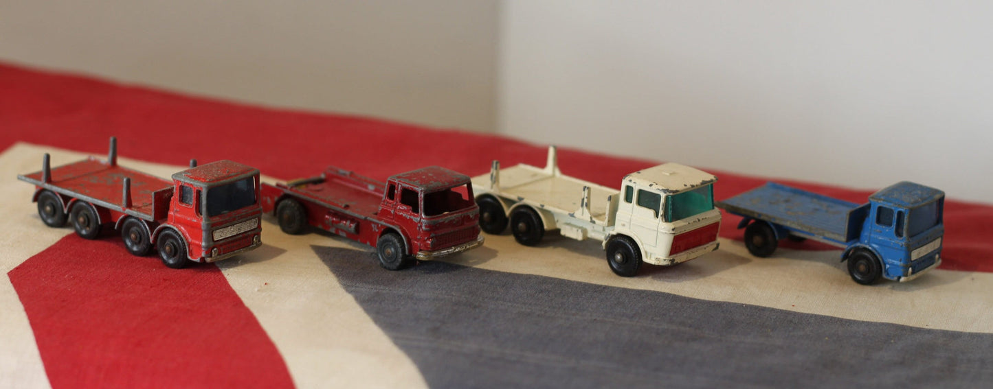 Four Diecast Metal Matchbox Lesney and Husky Toy Trucks From The 1960's