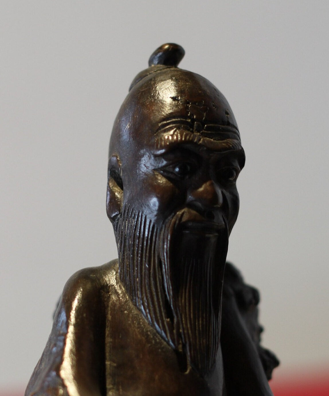 A Chinese Root Wood Hand Carving of an Elder Raised on a Later Oval Ebony Base, Overall 23.5cm High