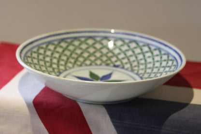 an oriental blue and green decorated shallow bowl with unglazed foot 23cm diameter