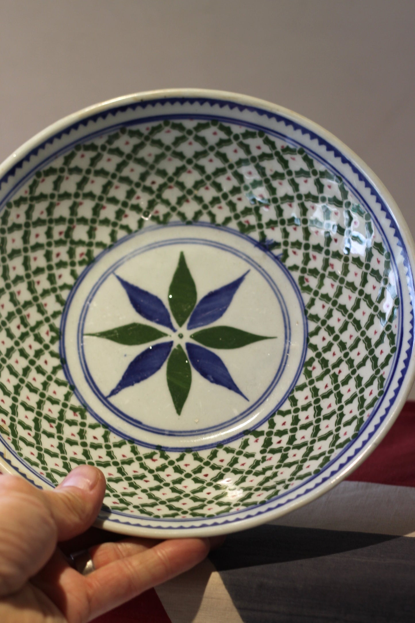 an oriental blue and green decorated shallow bowl with unglazed foot 23cm diameter