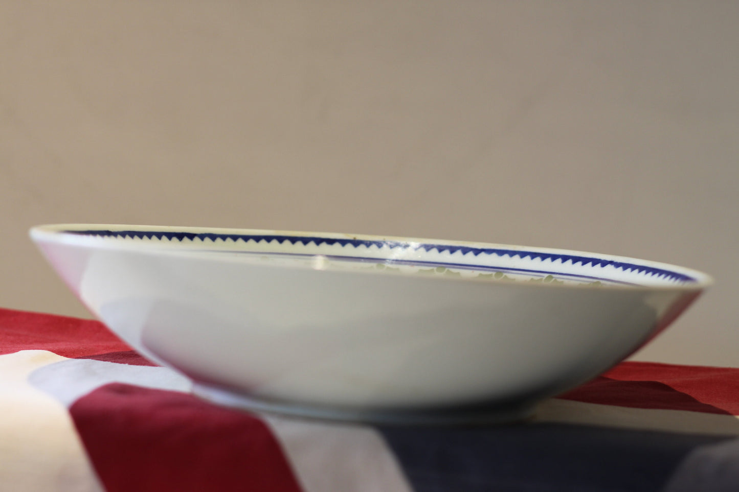 an oriental blue and green decorated shallow bowl with unglazed foot 23cm diameter