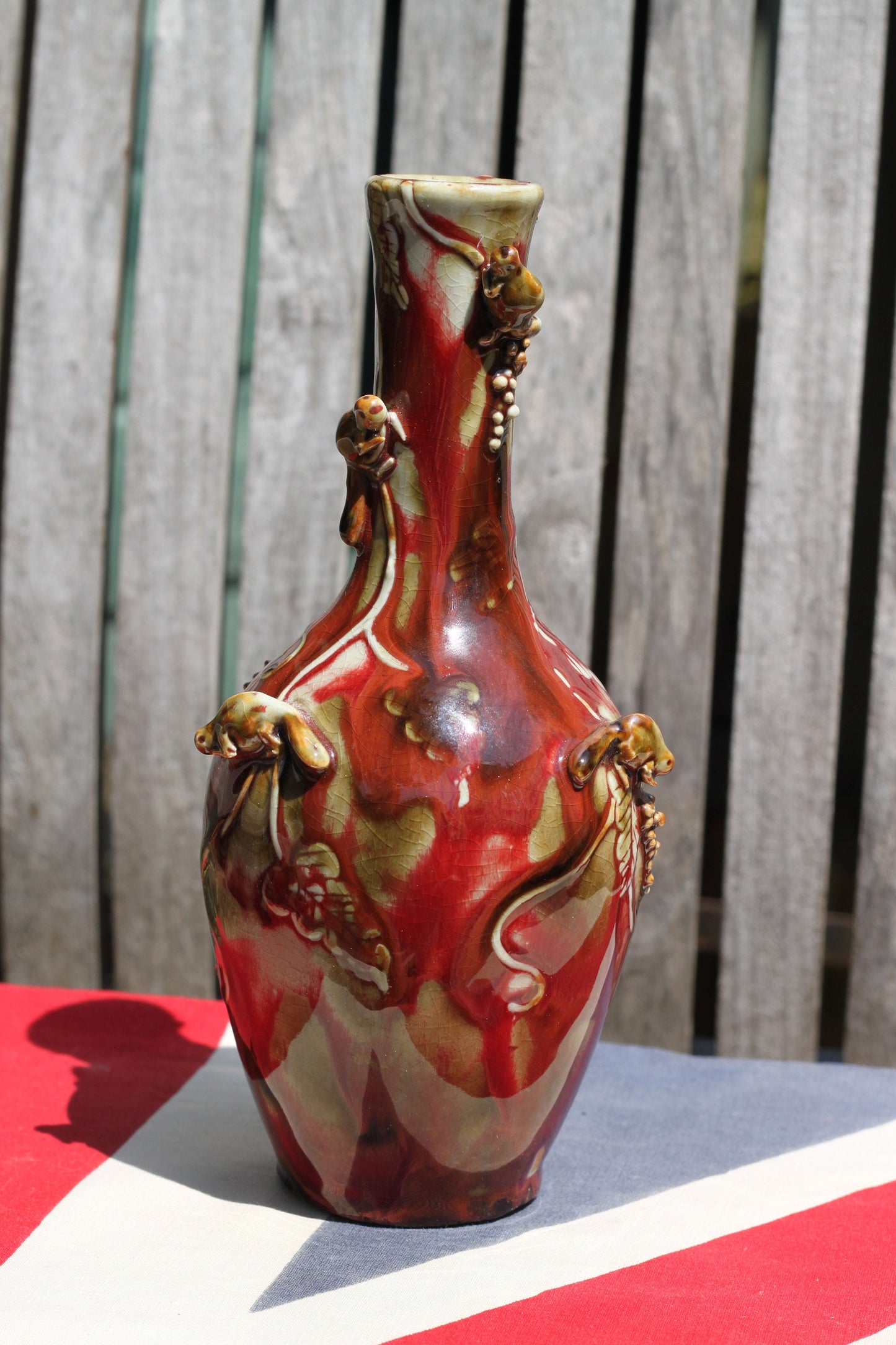 A Chinese Flambe Vase Decorated With Small Creatures Climbing a Vine  22cm Tall