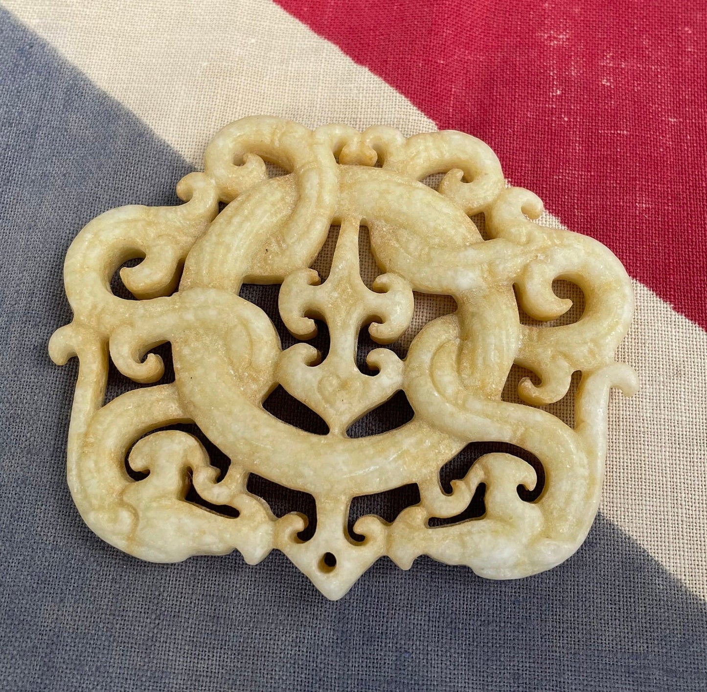 A Chinese Hardstone Disc Pendant Carving of two entwined dragons 7cm Across