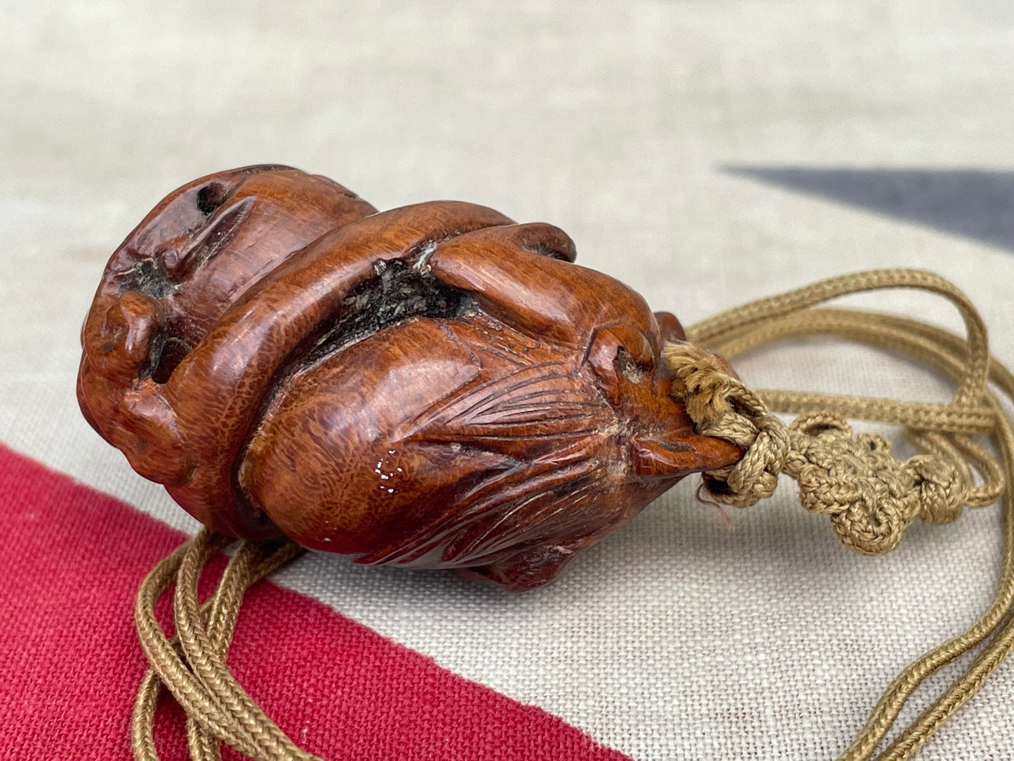 A Hand Carved Wooden Dress Toggle of a Chinese Mythical Beast on a Silk Cord 4.5cm Long