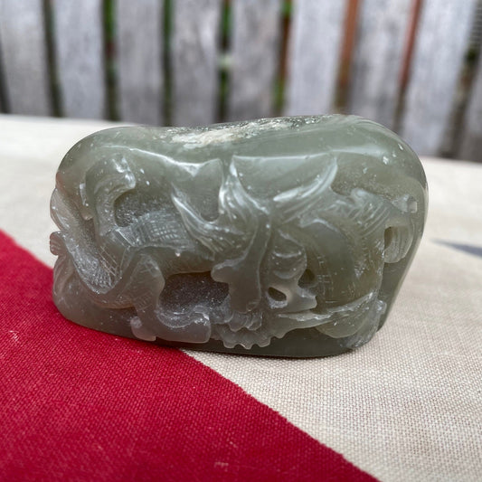 A Chinese Green Jade Pebble Hand Carved in Relief With a Dragon 6cm Wide