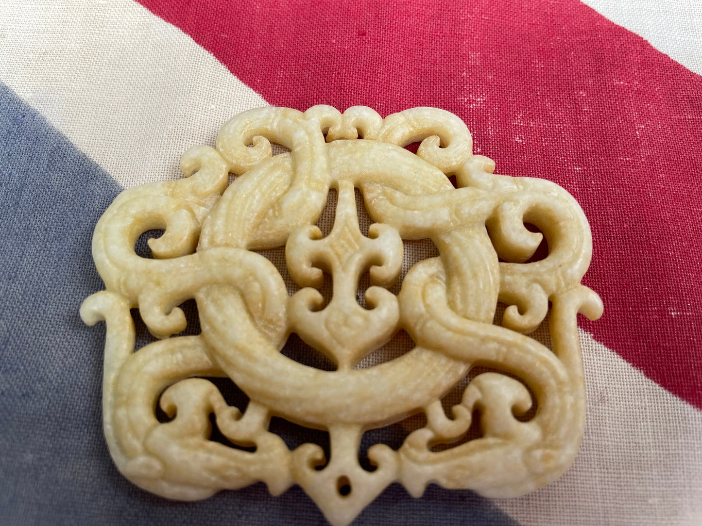 A Chinese Hardstone Disc Pendant Carving of two entwined dragons 7cm Across