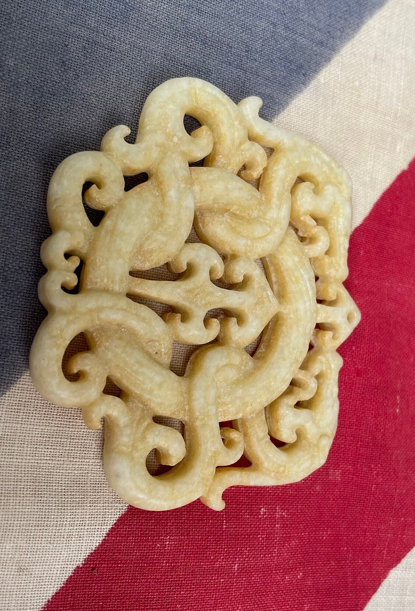 A Chinese Hardstone Disc Pendant Carving of two entwined dragons 7cm Across