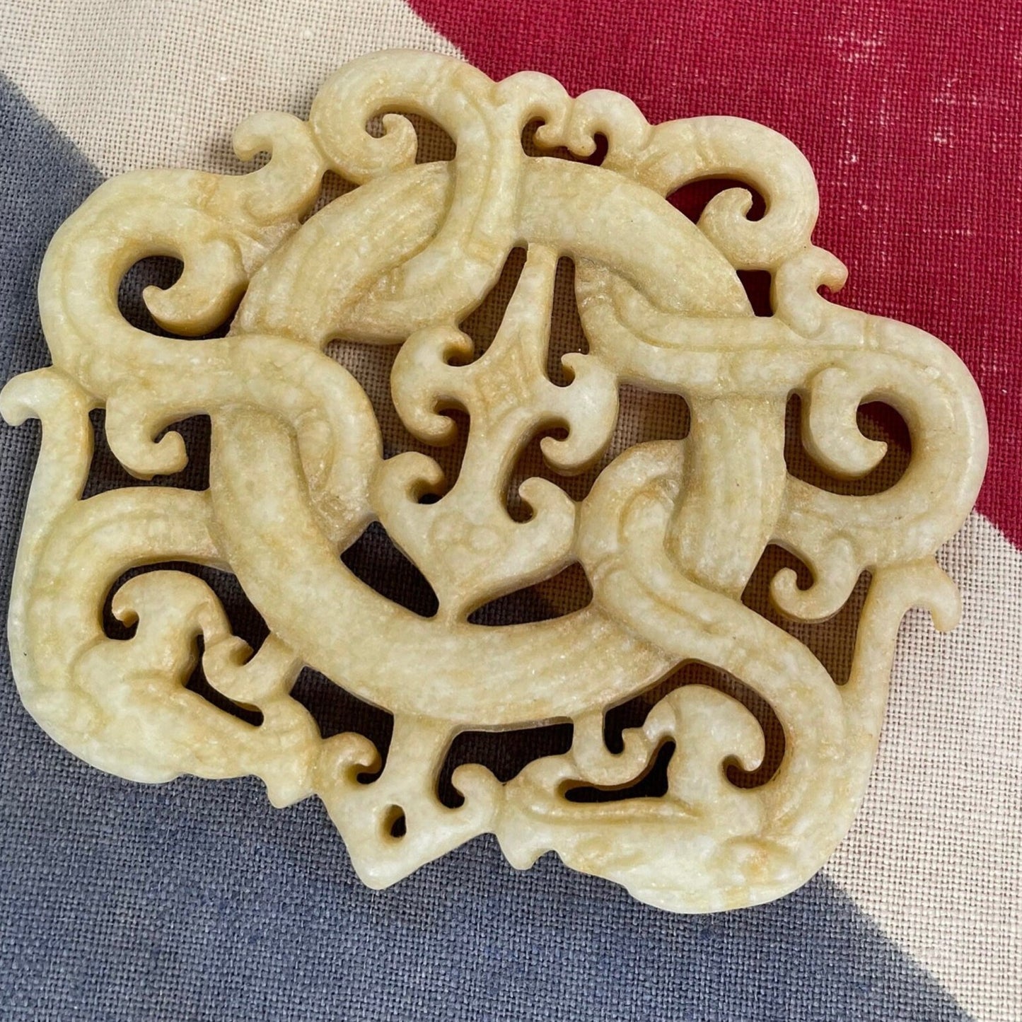 A Chinese Hardstone Disc Pendant Carving of two entwined dragons 7cm Across