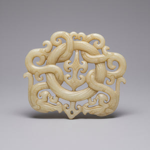 A Chinese Hardstone Disc Pendant Carving of two entwined dragons 7cm Across
