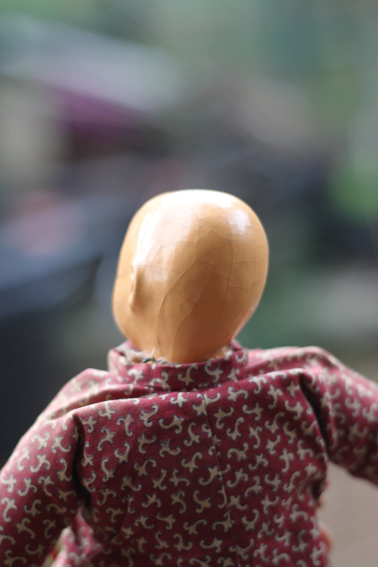 An early 20th century Chinese lacquered doll with cloth body, 24cm high