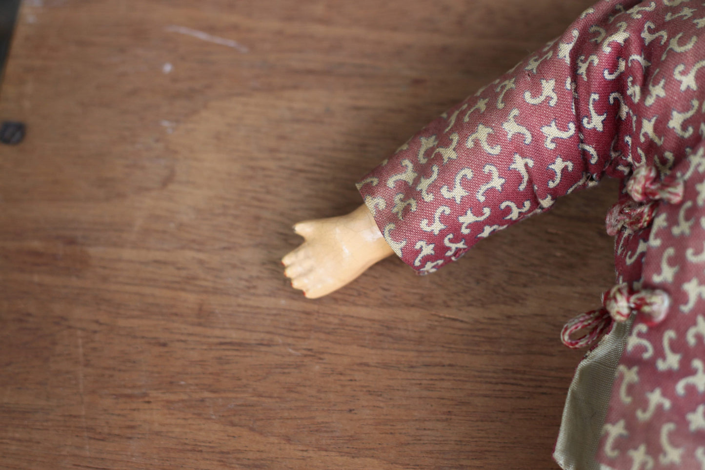 An early 20th century Chinese lacquered doll with cloth body, 24cm high