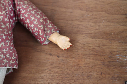 An early 20th century Chinese lacquered doll with cloth body, 24cm high