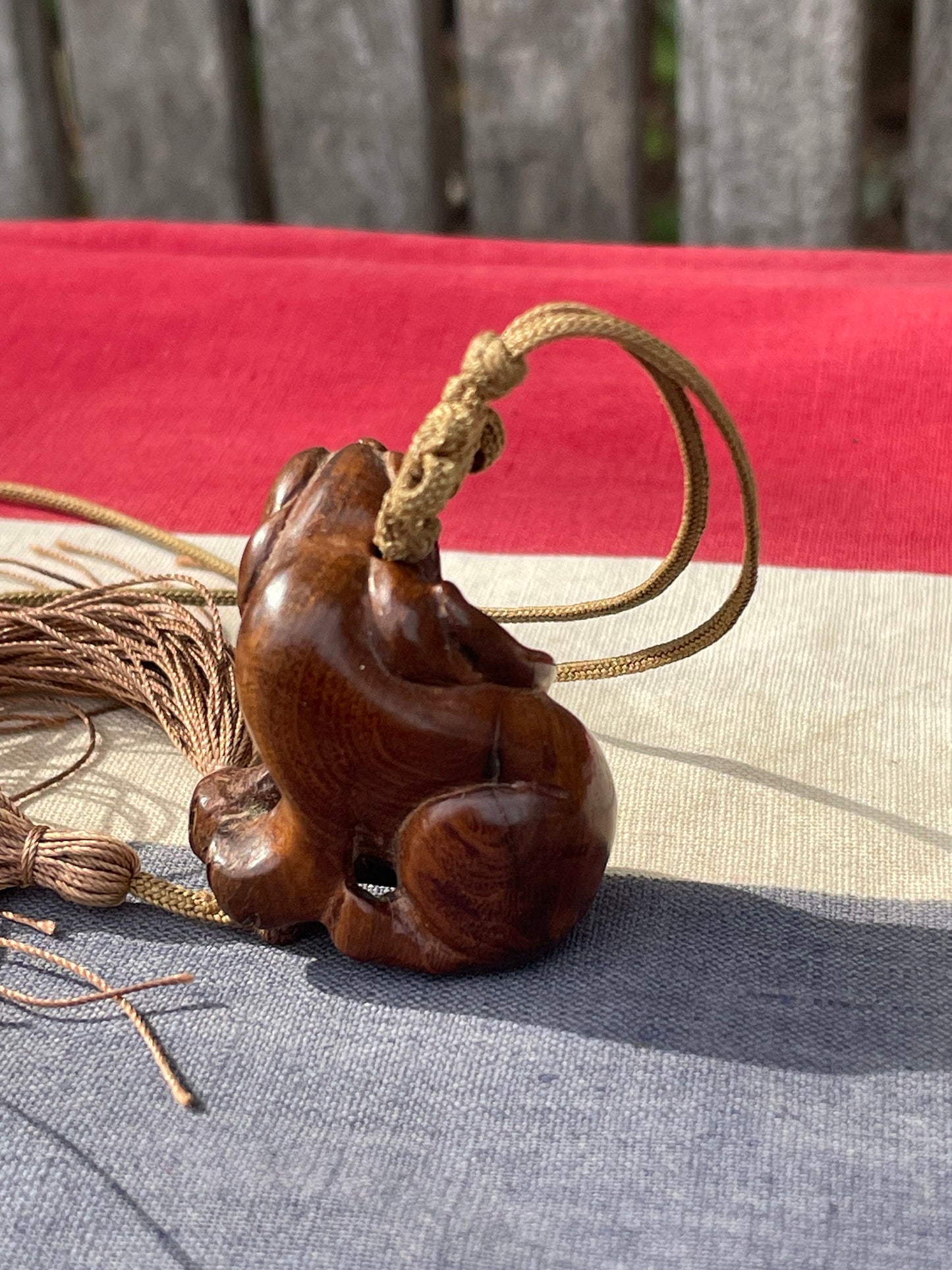 A Hand Carved Hard Wood Dress Toggle of a Chinese Foo Dog on a Silk Cord 4cm Long