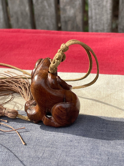 A Hand Carved Hard Wood Dress Toggle of a Chinese Foo Dog on a Silk Cord 4cm Long