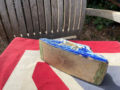 An 18th Century Dutch Delft Pottery Desk Blotter With Polychrome Design of a Dog, Length 17cm